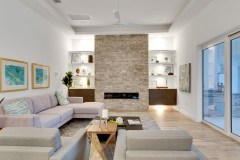 Living room with stone fireplace - model hom in Orlando, Florida