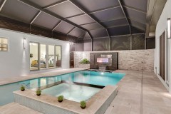 Pool and spa with gas fireplace - Palm Coast model home